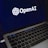 A laptop screen displaying the OpenAI logo and text. The laptop keyboard is visible below, with keys illuminated in a dimly lit environment.